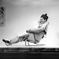Ray Eames sitting on an experimental lounge chair Ray Eames sitting on an experimental lounge chair